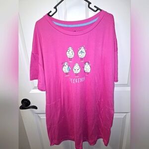 A Secret Treasures pink sleep shirt in a size L/XL with 2 pockets on front.